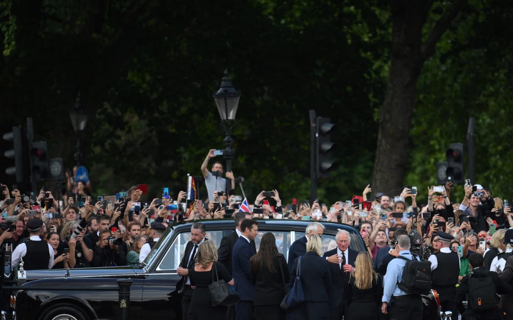 King Charles III and Camilla, Queen Consort greet the crowd upon their arrival Buckingham Palace in London, a day after Queen Elizabeth II died.