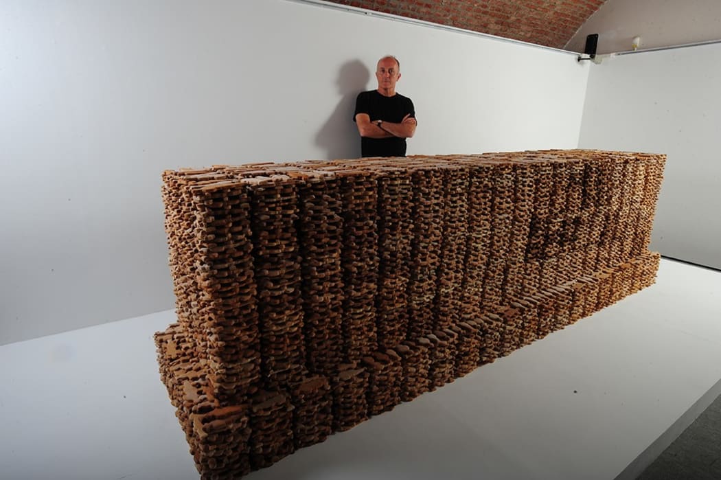 Kingsley Baird with his temporary artwork, Tomb, displayed at French World War I museum, Historial de la Grande Guerre, Péronne, 2013. The sculpture, a 1:1 ‘copy’ of Sir Edwin Lutyens’s "Stone of Remembrance" was composed of about 18,000 soldier-shaped biscuits.