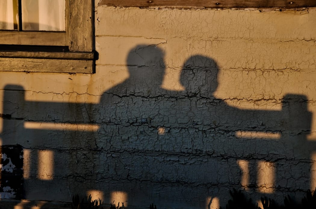 shadow of two people talking
