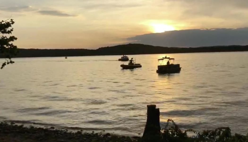 This video grab taken from handout footage released by the Southern Stone County Fire Protection District shows crews working at the scene where a tourist boat capsized and sank