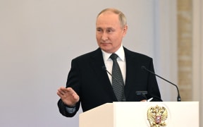 This pool photograph distributed by Russian state agency Sputnik shows Russia's President Vladimir Putin attending a ceremony to present Gold Star medals to Heroes of Russia on the eve of the Heroes of the Fatherland Day at the St. George Hall of the Grand Kremlin Palace in Moscow on 8 December, 2023. Russian leader Vladimir Putin has decided to run in presidential elections next March, news agencies reported on 8 December, 2023, allowing the Kremlin leader to extend his decades-long grip on power. Putin told Lieutenant Colonel Artyom Zhoga, a Russian military officer, about his decision to participate in the upcoming vote following an awards ceremony for army personnel at the Kremlin, state-run news agencies reported.