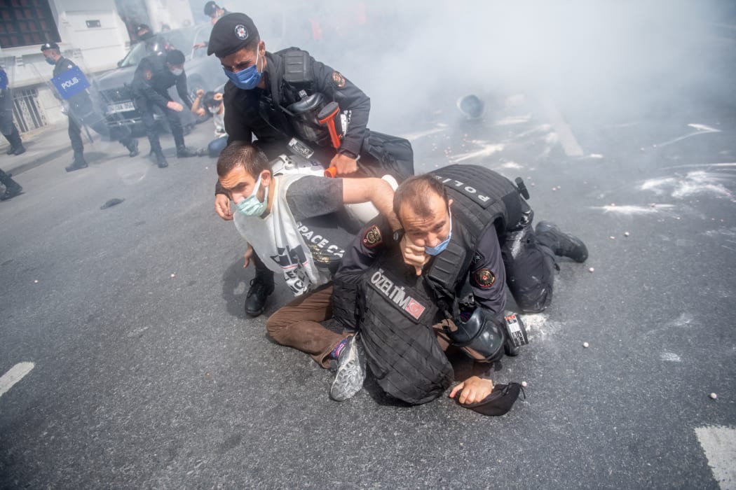 Turkish police detain demonstrators as they attempted to march on Taksim Square in Istanbul.