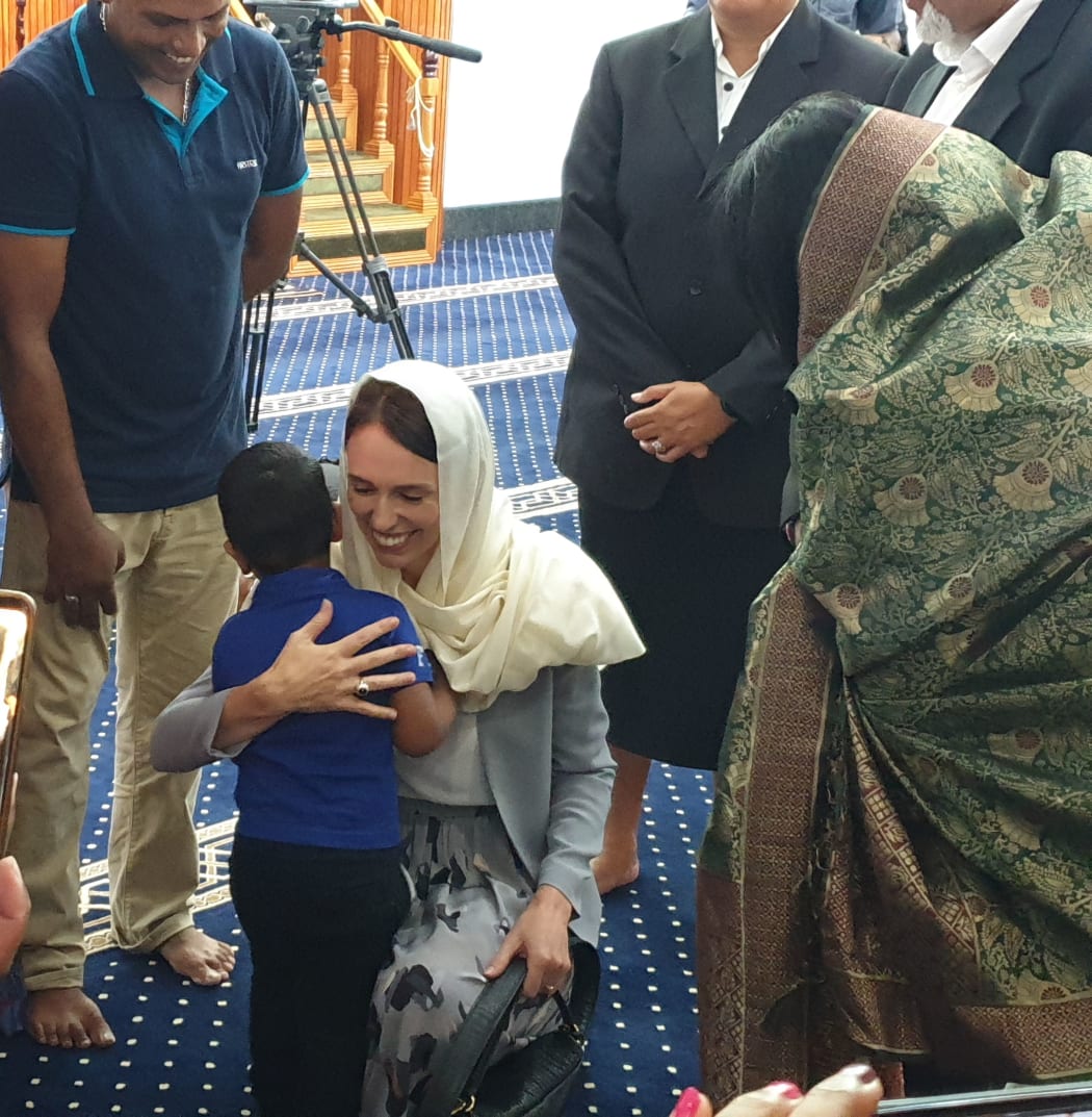 Ardern hugs the great grandson of Ashraf Ali Razak, who died in the mosque attack.