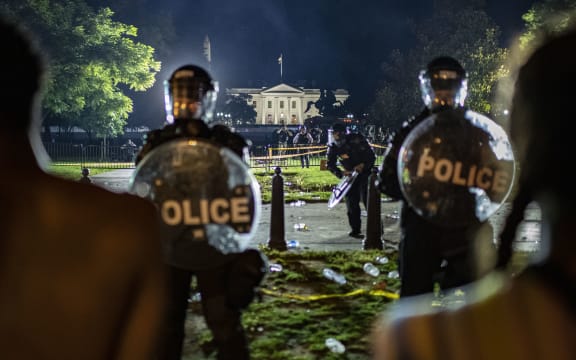 Demonstrators confront secret service police and Park police officers outside of the White House on May 30, 2020 in Washington DC.