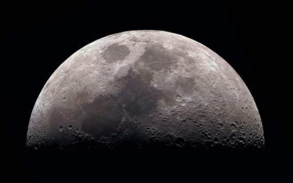 Moon, view through a telescope. The moon with craters. Real photos of space objects through a telescope. Natural background.