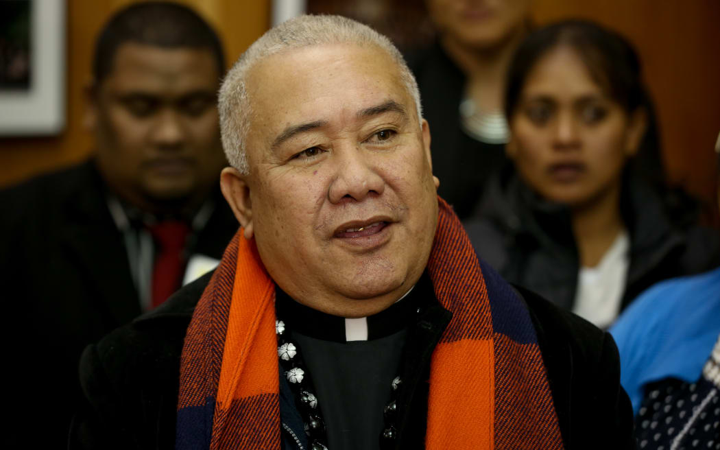 Reverend Iosefa Suamalie at Parliament handing over the Climate Change Petition.