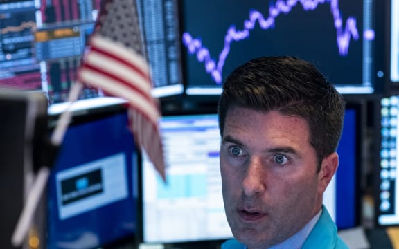 Traders work after the closing bell at the New York Stock Exchange (NYSE).