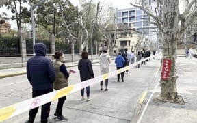 Local residents line to take PCR test under the lockdowns in Shanghai this month. The lockdowns are impacting on the economy, alongside Western sanctions against Russia.