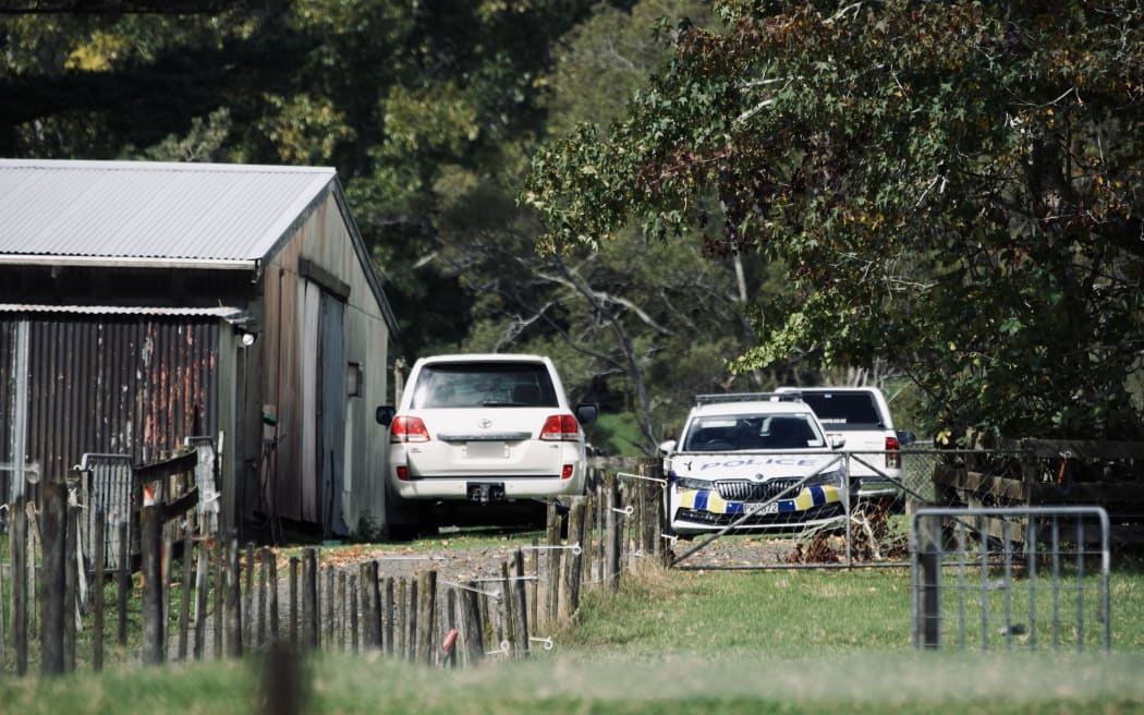 Police cars at a property on Anzac Valley Rd in rural Waitākere, west Auckland, on 18 April 2024.