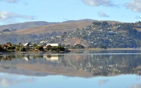 A panorama of Christchurch estuary in the foreground with the hill suburb of Redcliffs in the background.