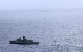 This handout photo taken on February 13, 2025 and released by The Australian Defence Force shows the Royal Australian Navy ship HMAS Arunta (lower L) sailing near the People's Liberation Army-Navy (PLA-N) Fuchi-class replenishment vessel and Weishanhu Jiangkai-class frigate Hengyang in the Tasman Sea. Australia's foreign minister voiced concern on February 21 over live fire drills conducted by three Chinese warships sailing off the country's east coast. (Photo by Handout / AUSTRALIAN DEFENCE FORCE / AFP) / RESTRICTED TO EDITORIAL USE - MANDATORY CREDIT "AFP PHOTO /  AUSTRALIAN DEFENCE FORCE" - NO MARKETING NO ADVERTISING CAMPAIGNS - DISTRIBUTED AS A SERVICE TO CLIENTS