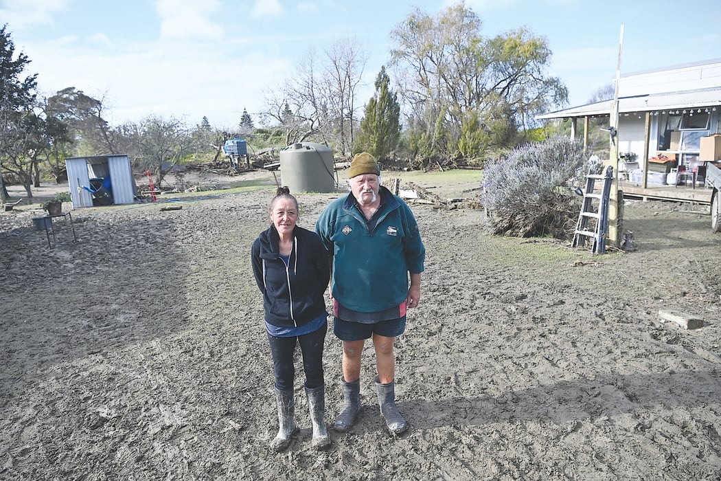 Tokomaru Bay residents Jan and Rick Whaitiri standing in the deluge of mud and silt left behind by severe rain over the weekend.
