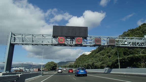 Speed signs on gantries above the Wellington motorway.