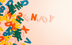 random colourful letters on a pink background