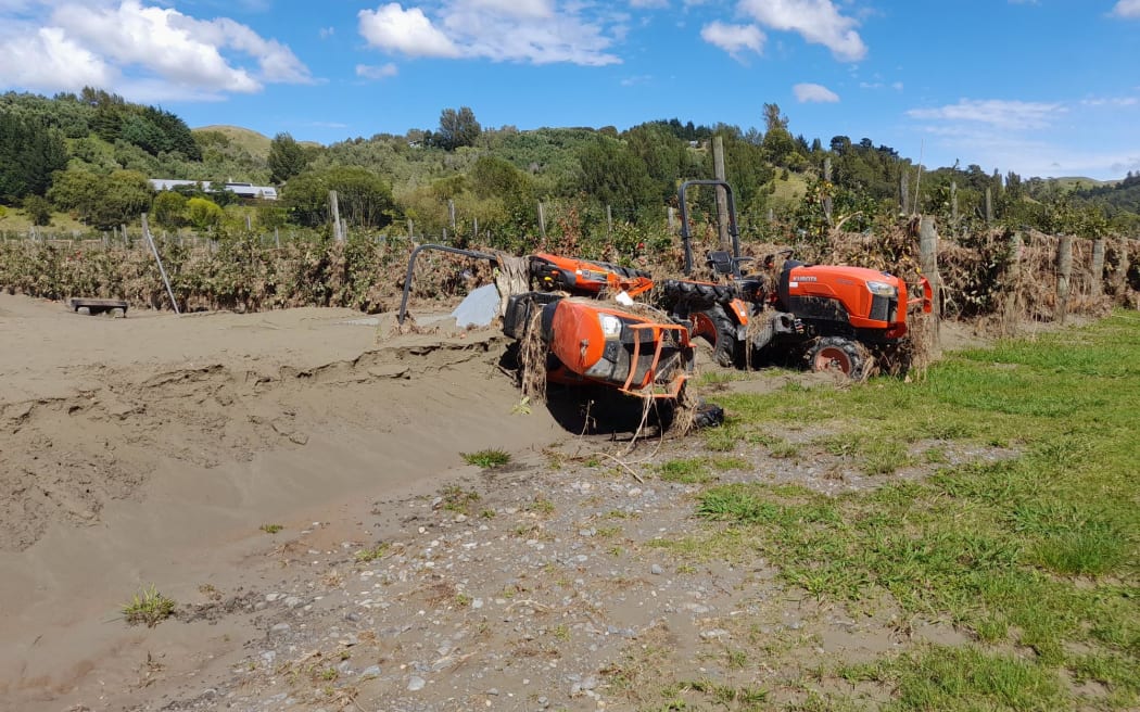 Thick silt and upended tractors lie at the front of Pheasant Farm, Esk Valley, in the wake of Cyclone Gabrielle.