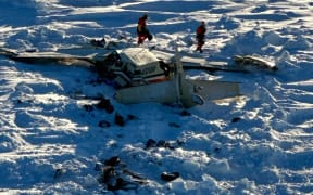 This image obtained from the US Coast Guard (USCG) on February 7, 2025, shows the remains of a plane reported missing February 6. The Bering Air Caravan was carrying nine passengers and one pilot on board. The search ended after the aircraft was located some 34 miles (55kms) southeast of Nome, Alaska. The USCG reported the three individuals were found inside and were deceased. "The remaining 7 people are believed to be inside the aircraft but are currently inaccessible due to the condition of the plane," according to a statement posted on the X of the USCG. (Photo by Handout / US Coast Guard / AFP) / RESTRICTED TO EDITORIAL USE - MANDATORY CREDIT "AFP PHOTO / US COAST GUARD" - NO MARKETING NO ADVERTISING CAMPAIGNS - DISTRIBUTED AS A SERVICE TO CLIENTS