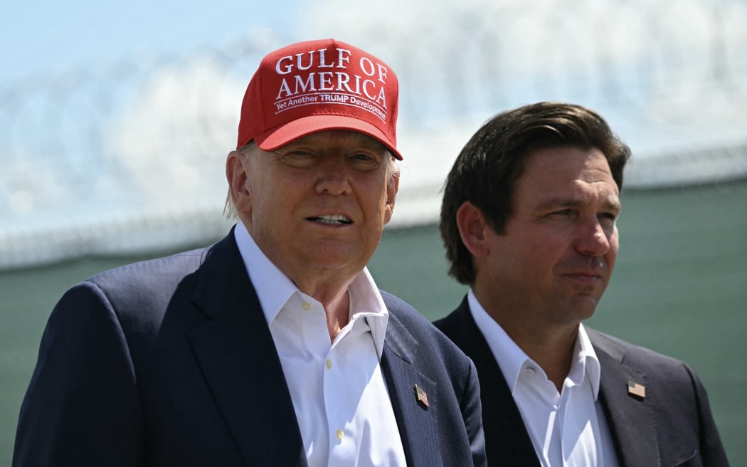 (L/R) US President President Donald Trump and Florida Governor Ron DeSantis tour a migrant detention center, dubbed "Alligator Alcatraz," located at the site of the Dade-Collier Training and Transition Airport in Ochopee, Florida on July 1, 2025. President Trump is visiting a migrant detention center in a reptile-infested Florida swamp dubbed "Alligator Alcatraz." Trump will attend the opening of the 5,000-bed facility -- located at an abandoned airfield in the Everglades wetlands -- part of his expansion of deportations of undocumented migrants, his spokeswoman said. (Photo by ANDREW CABALLERO-REYNOLDS / AFP)