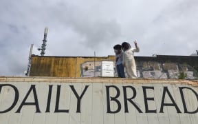 Jessie Baker shows Detail presenter Sharon Brettkelly an urban beehive in Pt Chevalier