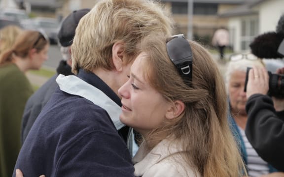 Former residents of the Bella Vista development comfort each other after announcing their rejection of the council's compensation offer.
