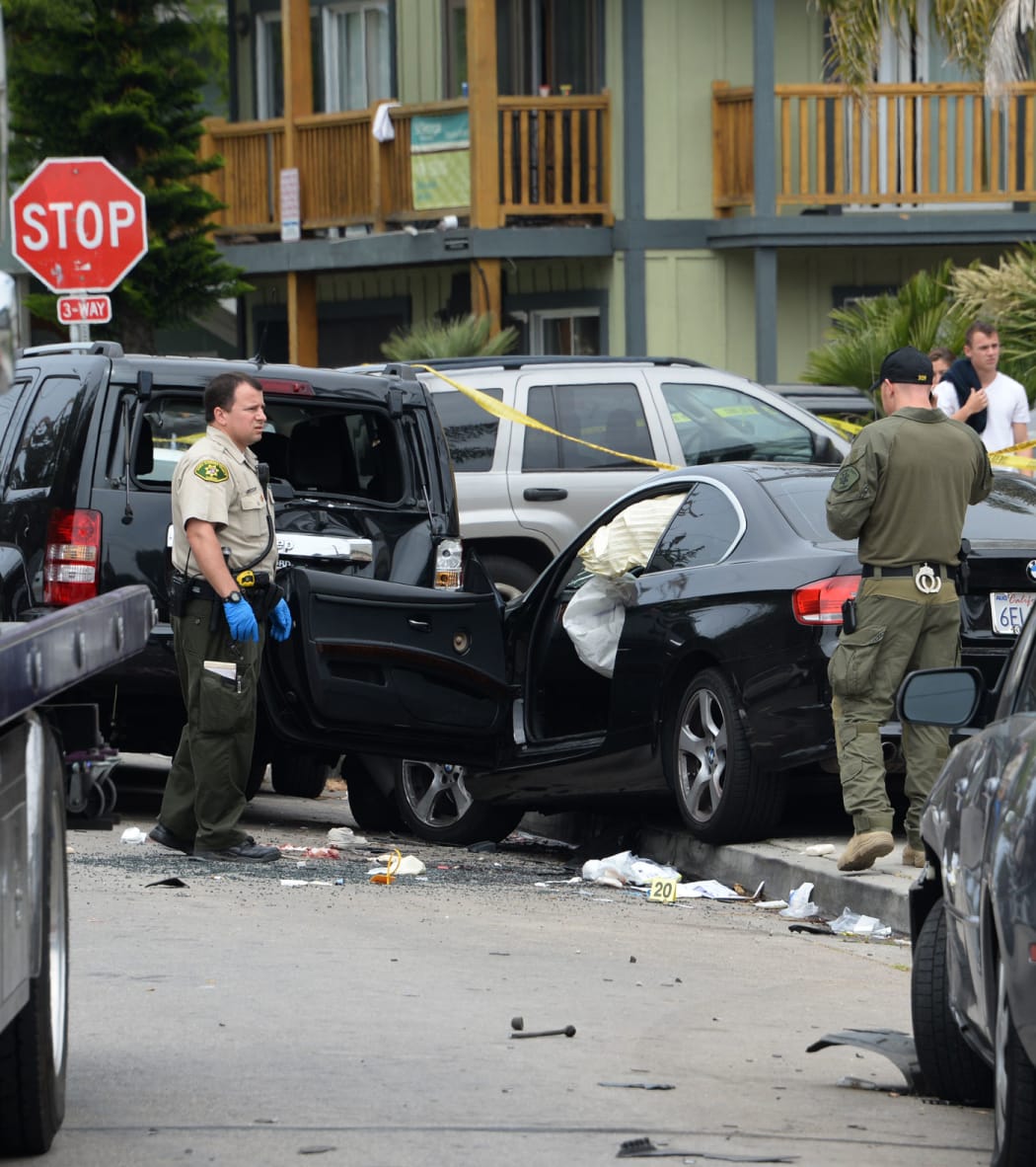 Police examine Elliot Rodger's crashed car the day after his rampage.