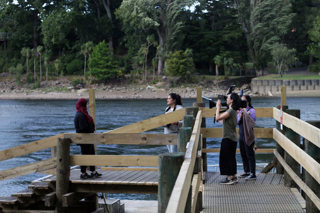 Left to right: Shaymaa Arif, Director Ghazaleh Golbakhsh, Director of Photography Kelly Chen, 1st Assistant Camera Nahyeon Lee on a jetty on the Waikato riverside.