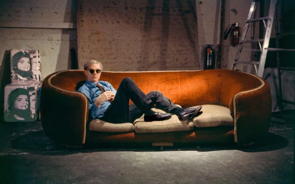 Andy Warhol on the red couch at the Factory. New York City, 1964.