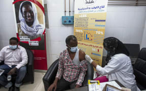 A man receives a dose of the Oxford-AstraZeneca COVID-19 coronavirus vaccine at the Jabra Hospital for Emergency and Injuries in Sudan's capital Khartoum on March 9, 2021.