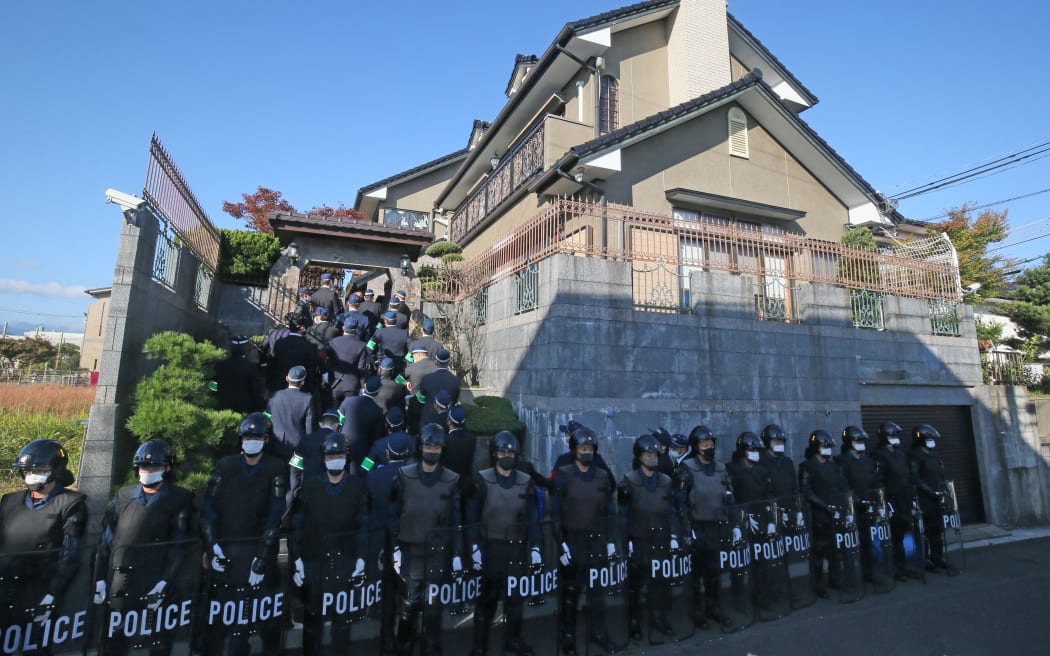 Investigators of Kyoto and Fukuoka Prefectural Police conduct an investigation at an office of the Japanese yakuza group Kudo-kai in Kasuga City, Fukuoka Prefecture on November 3, 2022.