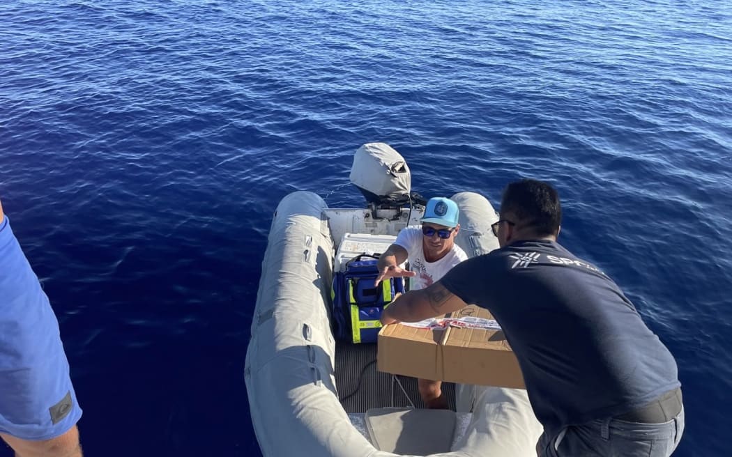 Medical transferring gear onto a raft that will head to Tematangi atoll