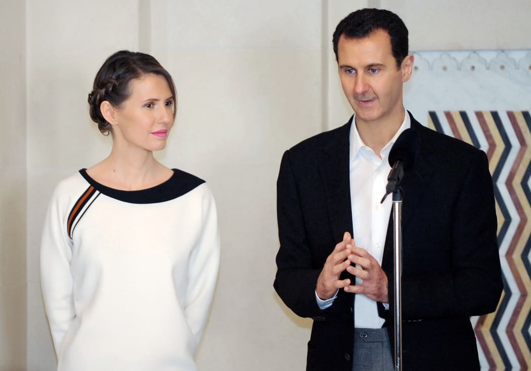 Syrian President Bashar al-Assad speaking next to his wife Asma as they receive members of the army and their mother's to celebrate Mother's Day.