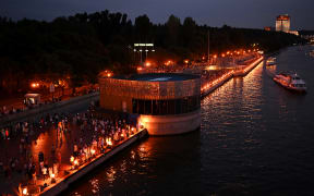 People enjoy the sunny evening dancing on the embankment of the Moskva River in central Moscow, on August 19, 2023.
