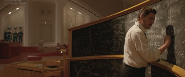 Marvel film Fantastic Four: First Steps actor Pedro Pascal writes mathematic equations in chalk on a blackboard.