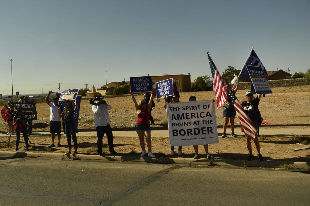 People protest as the motorcade with US Vice President Kamala Harris departs the US Customs and Border Protection Central Processing Center, in El Paso, Texas, during an official visit.