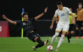Romania's midfielder Alexandru Dobre (right) is tackled by New Zealand's defender Dane Ingham during the Tokyo 2020 Olympic Games on 28 July, 2021.