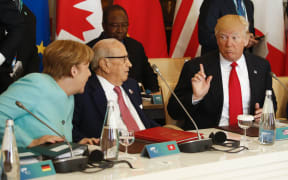German Chancellor Angela Merkel, 
Tunisia's President Beji Caid Essebsi and Donald Trump at the G7 Summit expanded session, on May 27, 2017 in Taormina, Sicily.