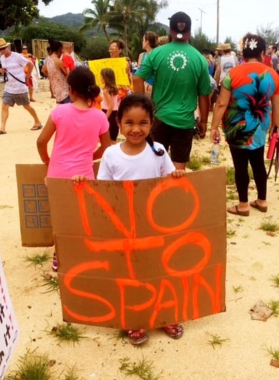 A young protester in the Cook Islands. The government has a draft agreement with the European Union for Spanish purse seine vessels to fish in its waters.