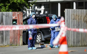 Police examine the scene in Riccarton, Christchurch where a person died overnight.