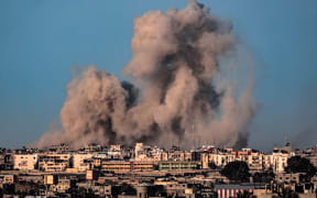 This picture taken from Rafah in the southern Gaza Strip shows smoke billowing during Israeli bombardment on Khan Yunis on February 22, 2024, amid continuing battles between Israel and the Palestinian militant group Hamas. (Photo by SAID KHATIB / AFP)