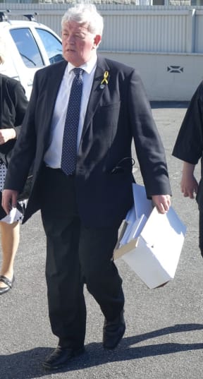 Bernie Monk, a spokesperson for some of the families, heads to the meeting.