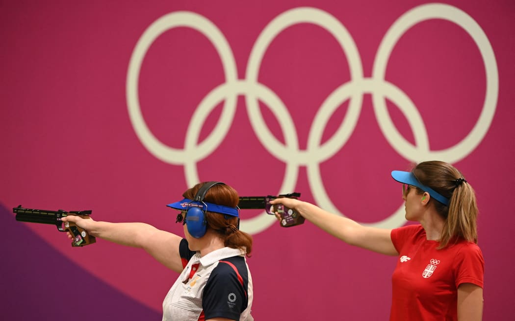 Georgia's Nino Salukvadze (R) and Serbia's Jasmina Milovanovic compete in the women’s 10m air pistol qualification during the Tokyo 2020 Olympic Games at the Asaka Shooting Range in the Nerima district of Tokyo on July 25, 2021. (Photo by Tauseef MUSTAFA / AFP)