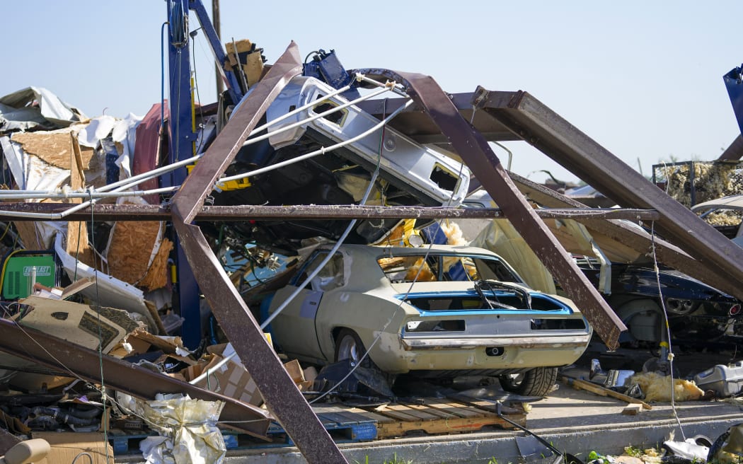 Vehicles in a body shop are seen amid debris the morning after a tornado rolled through, Sunday, May 26, 2024, in Valley View, Texas.