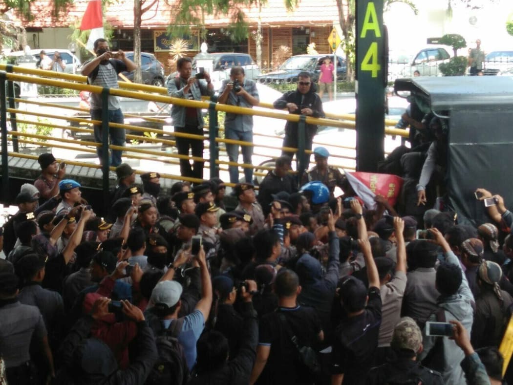 Protestors loaded on to a police truck, Yogyakarta 15 August 2017.