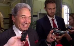 Winston Peters playing 'Radio Gaga' to press gallery reporters from his phone.