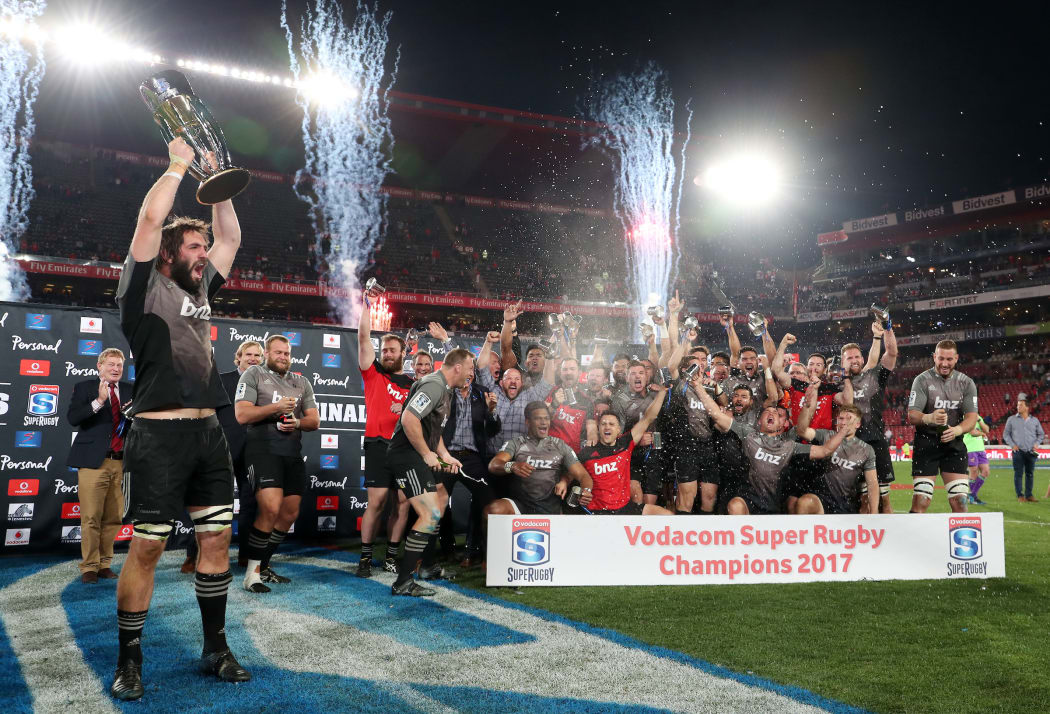 Crusader Sam Whitelock celebrates winning the 2017 Super Rugby trophy at Ellis Park Stadium.