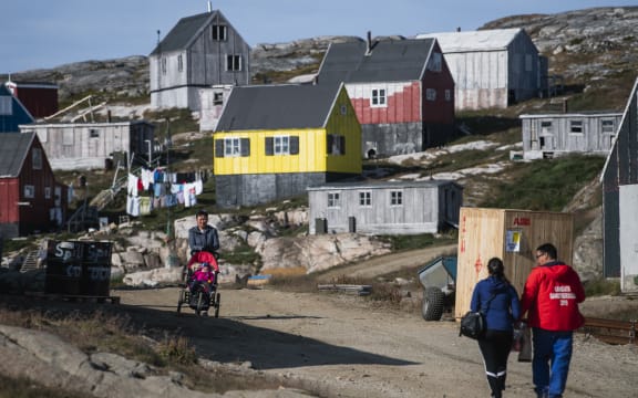People walking in Kulusuk, Greenland.