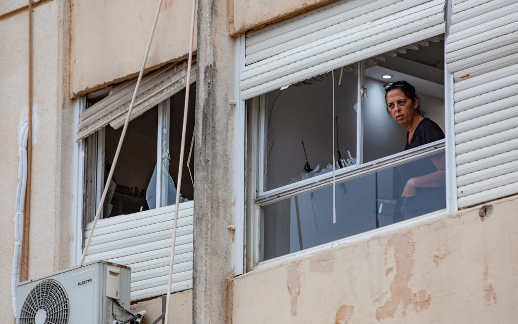 Residents and Israeli authorities inspect the damage following an overnight rocket attack from Lebanon in Haifa, Israel, on October 7, 2024. Several people are reported wounded, and the apparent Hezbollah attack also causes damage to homes and vehicles. (Photo by Mati Milstein/NurPhoto) (Photo by Mati Milstein / NurPhoto / NurPhoto via AFP)