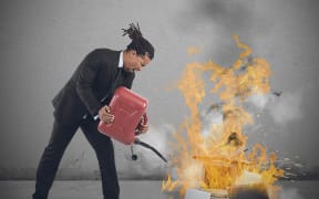 A businessman stressed and pissed burns computers.