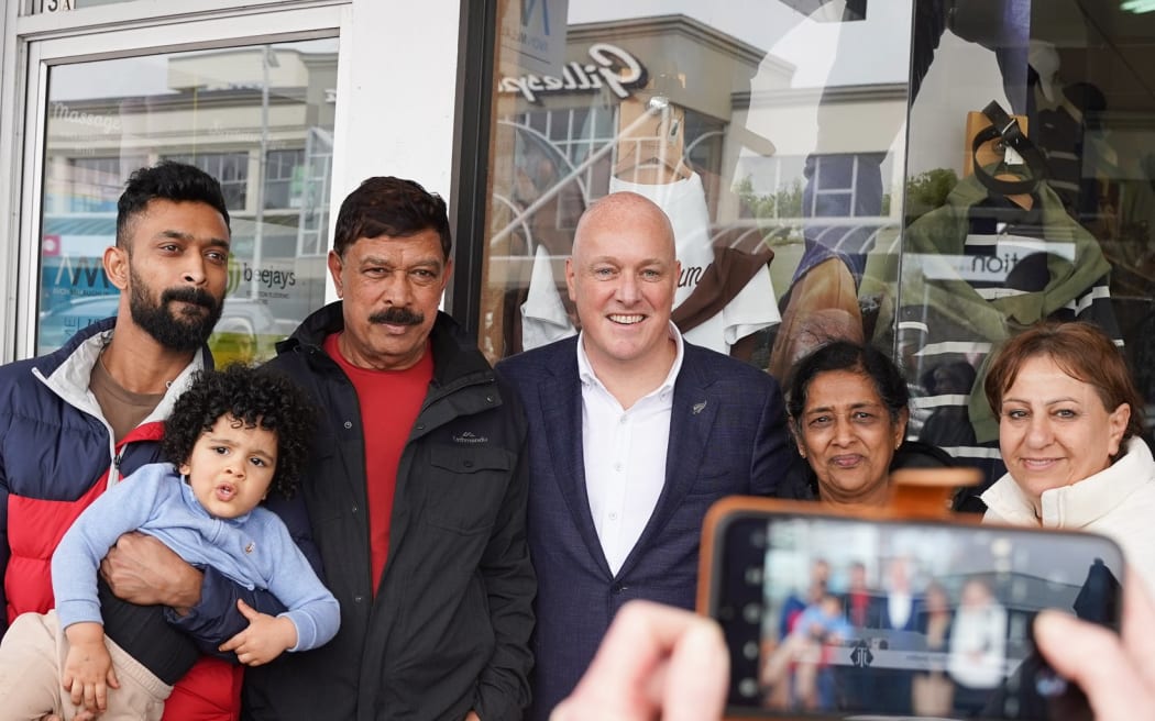 National leader Christopher Luxon with a family from Sri Lanka while out and about in Taupo on 23 September, 2023.