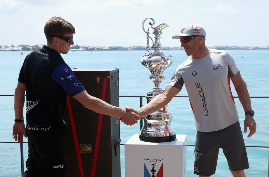 Team NZ helmsman Peter Burling, left, and Oracle Team USA's skipper Jimmy Spithill with the America's Cup Trophy, the Auld Mug.