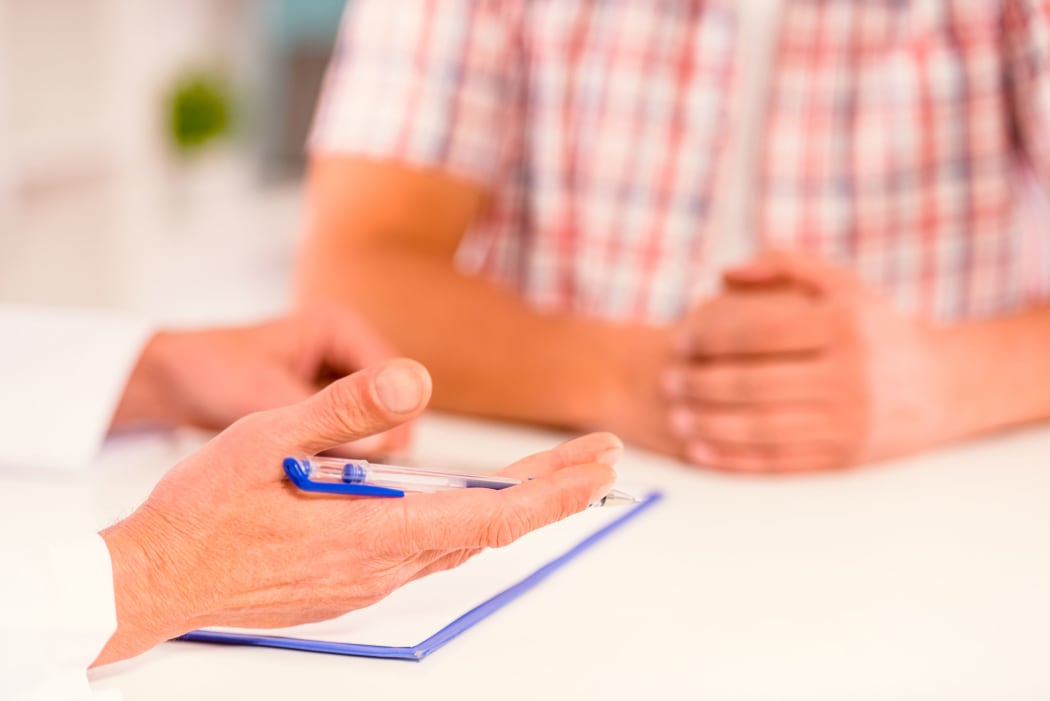 A doctor gives a male patient an update on his case (file photo)